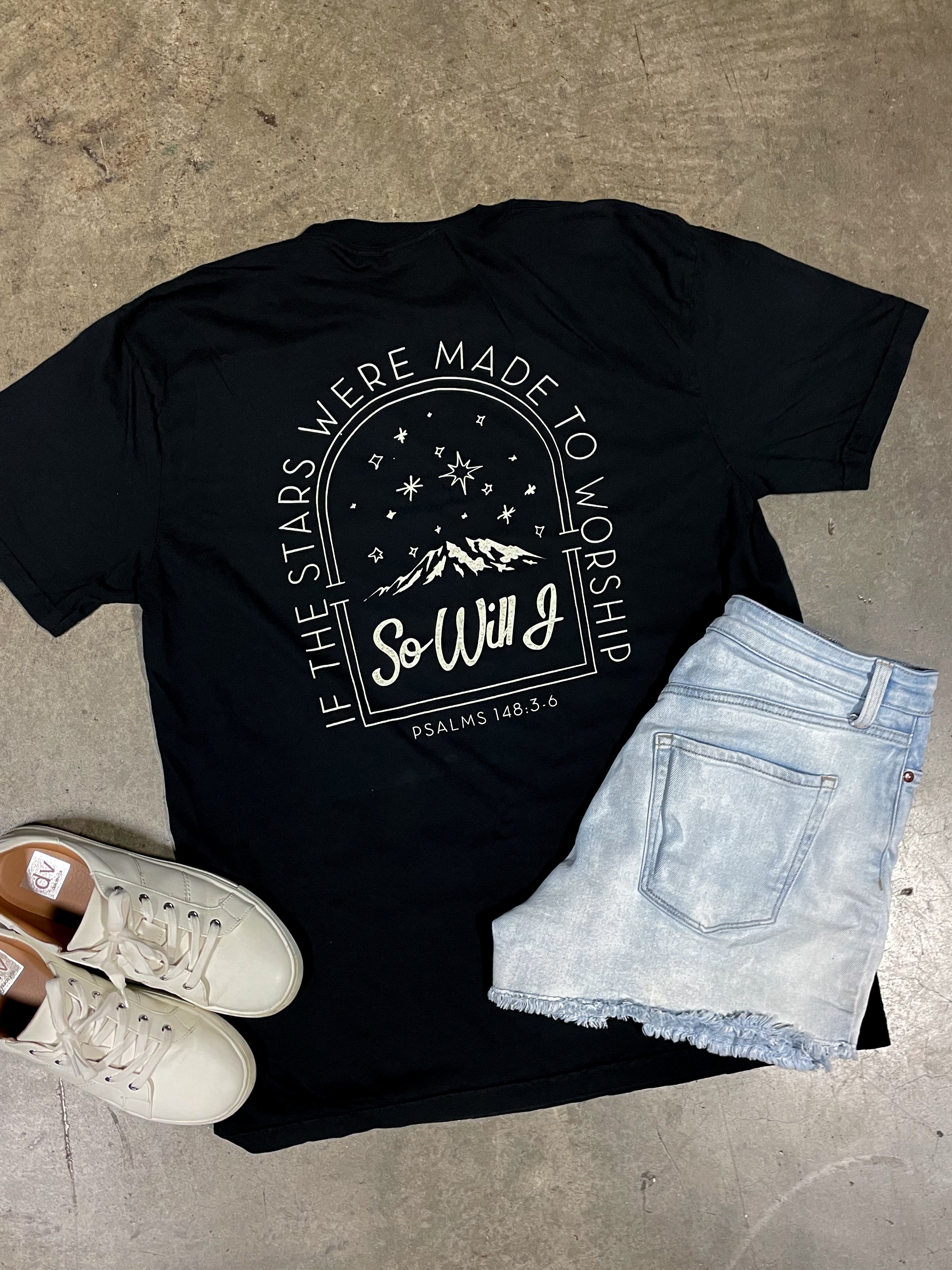a pair of shorts and a t - shirt on a concrete floor