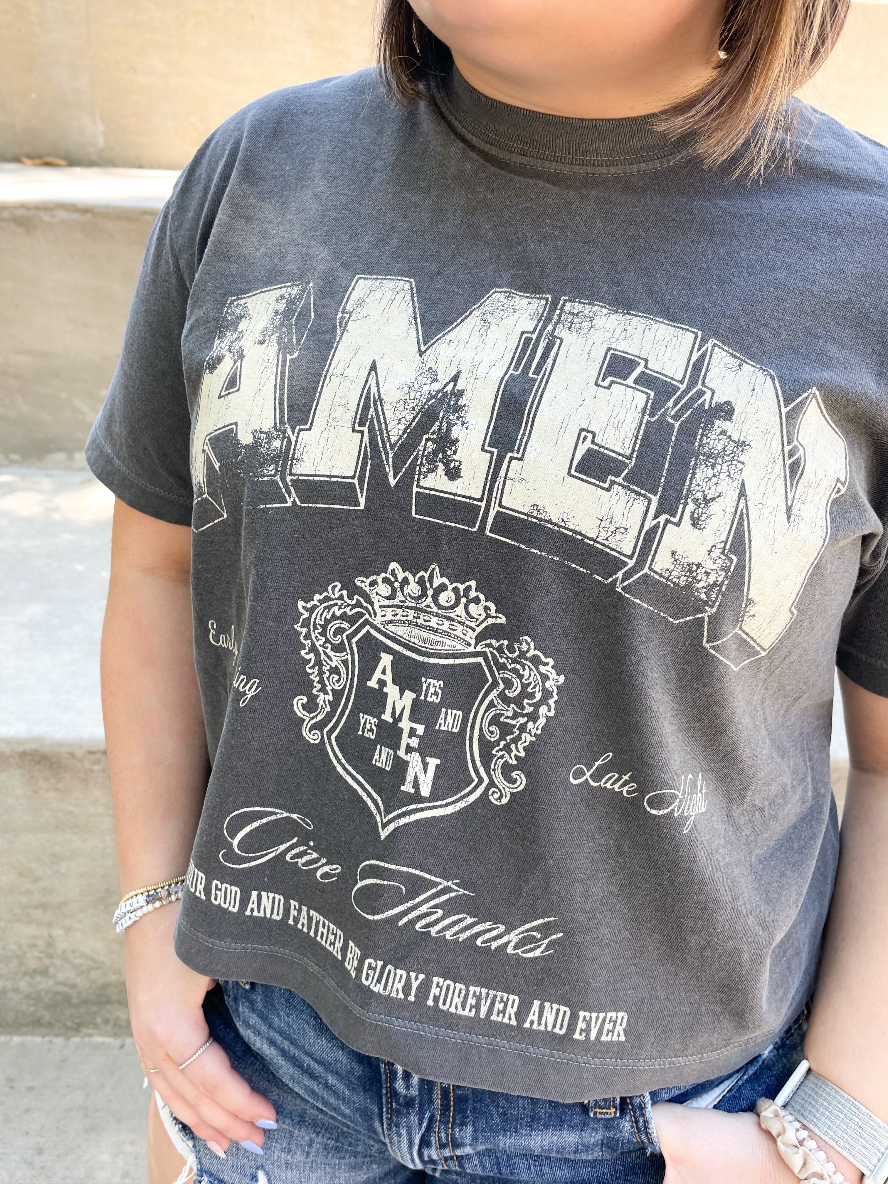 a woman wearing a t - shirt that says amen