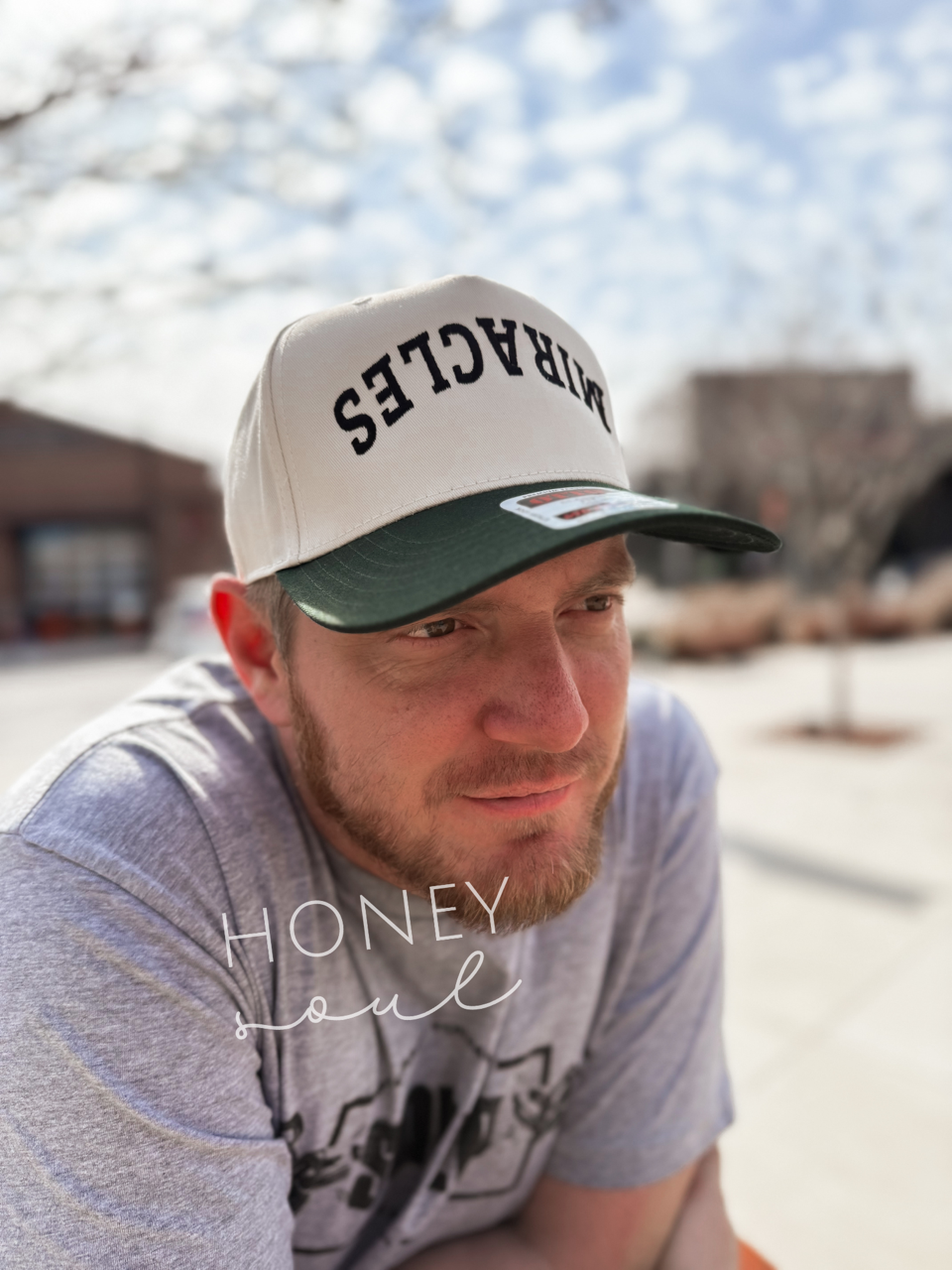 a man wearing a hat sitting on a bench