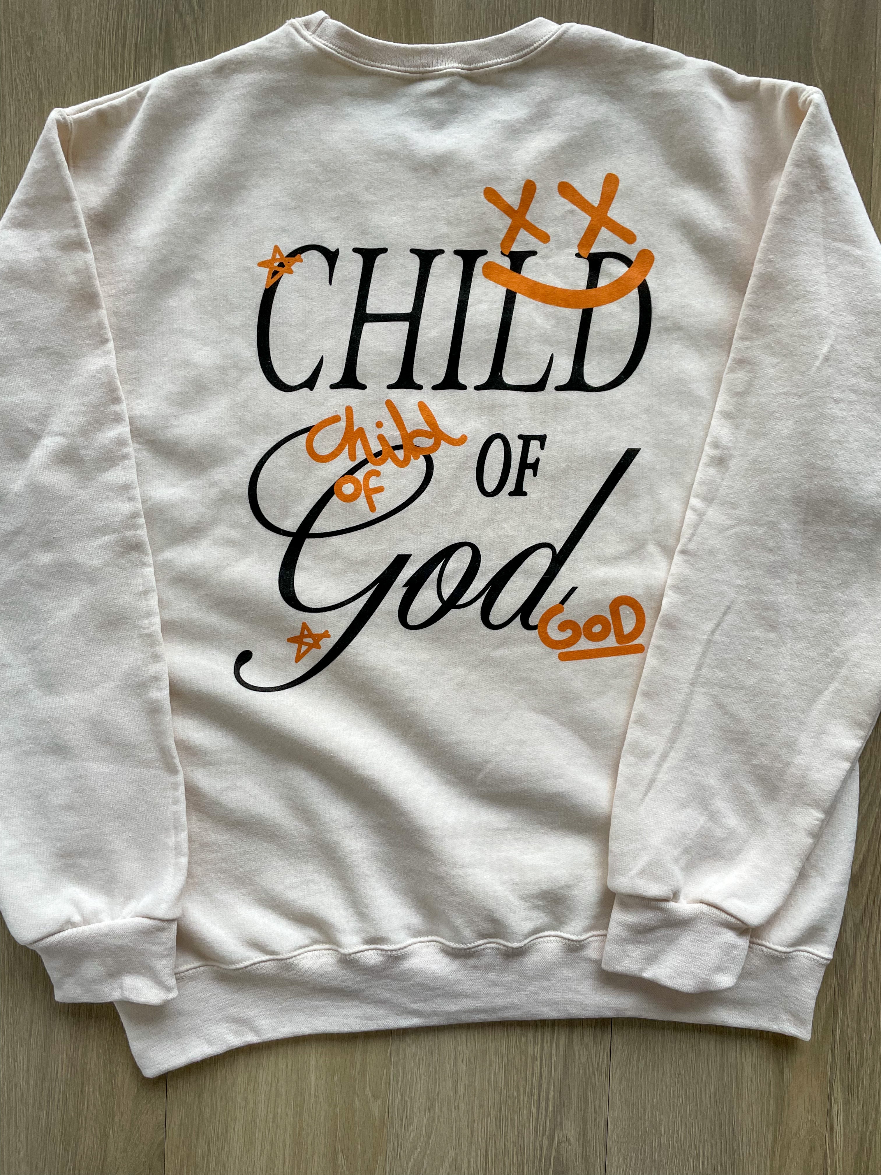 a white sweatshirt with the words child of god printed on it