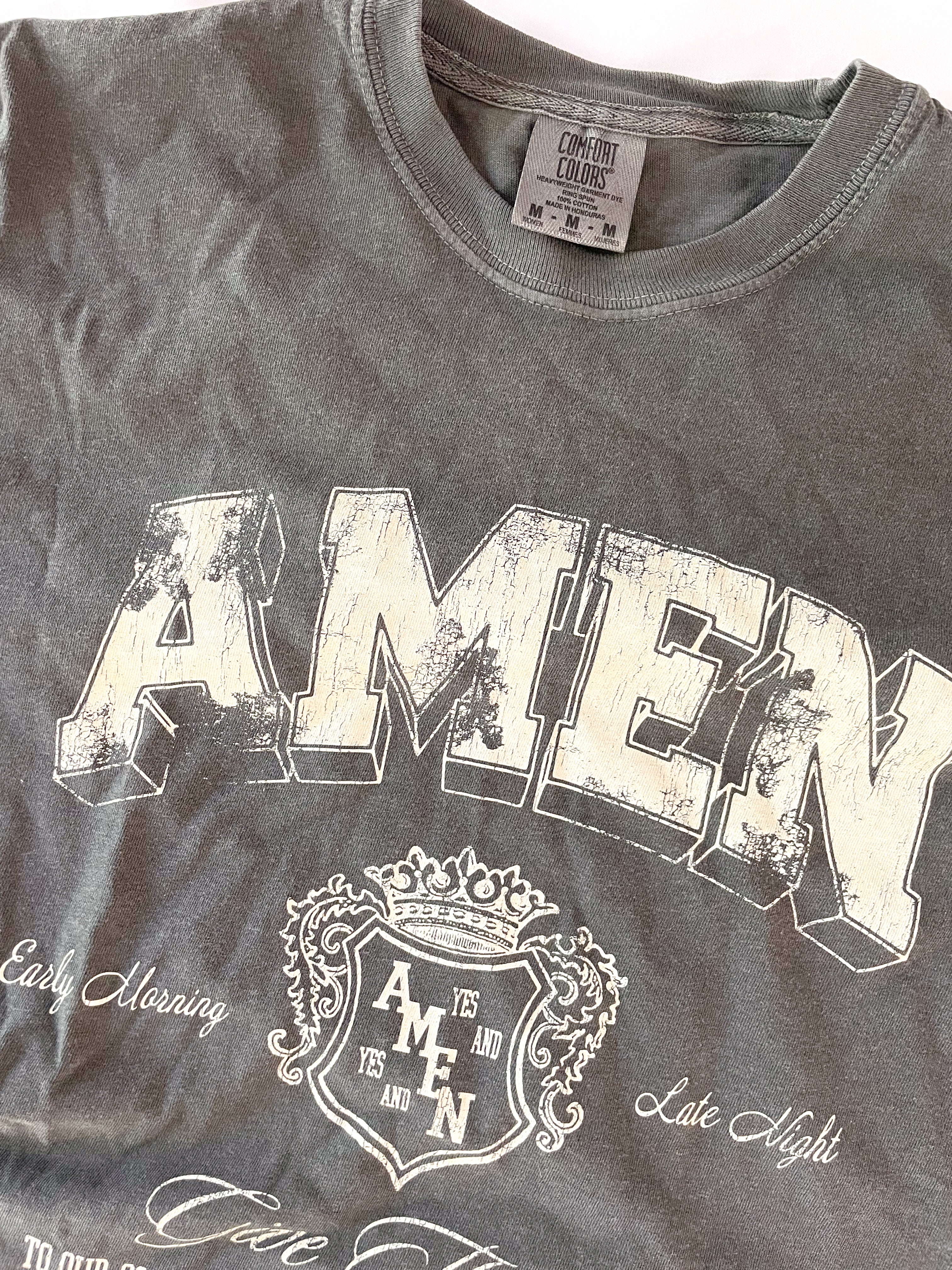 a gray t - shirt with the word amen printed on it