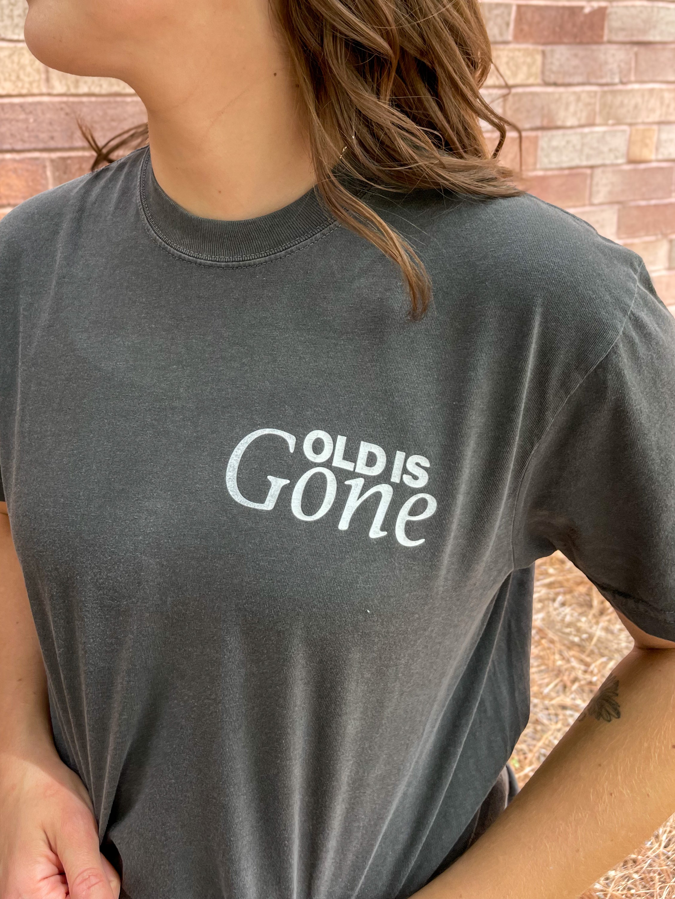 a woman wearing a black shirt with a white slogan on it