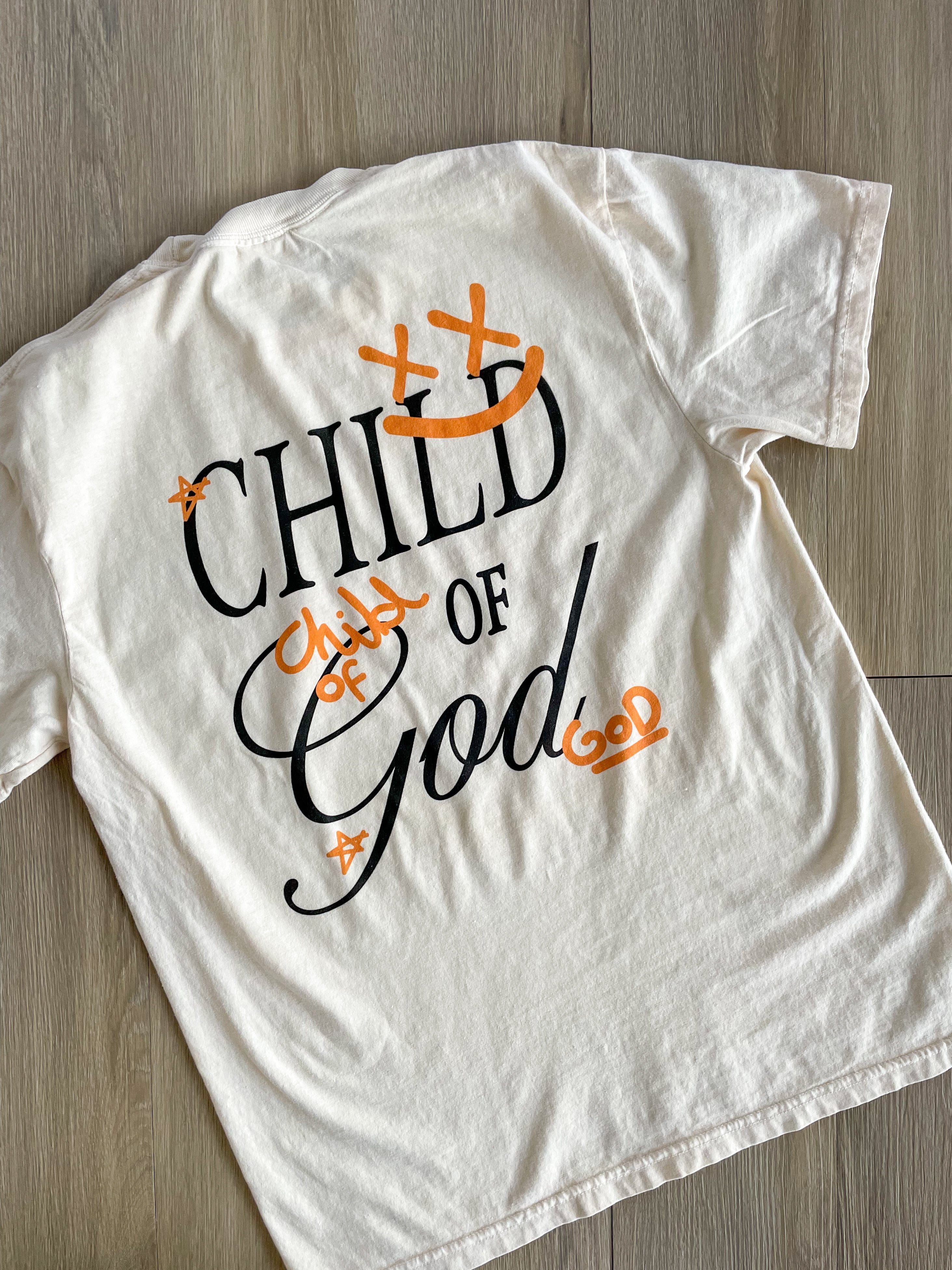 a t - shirt that says child of god on it
