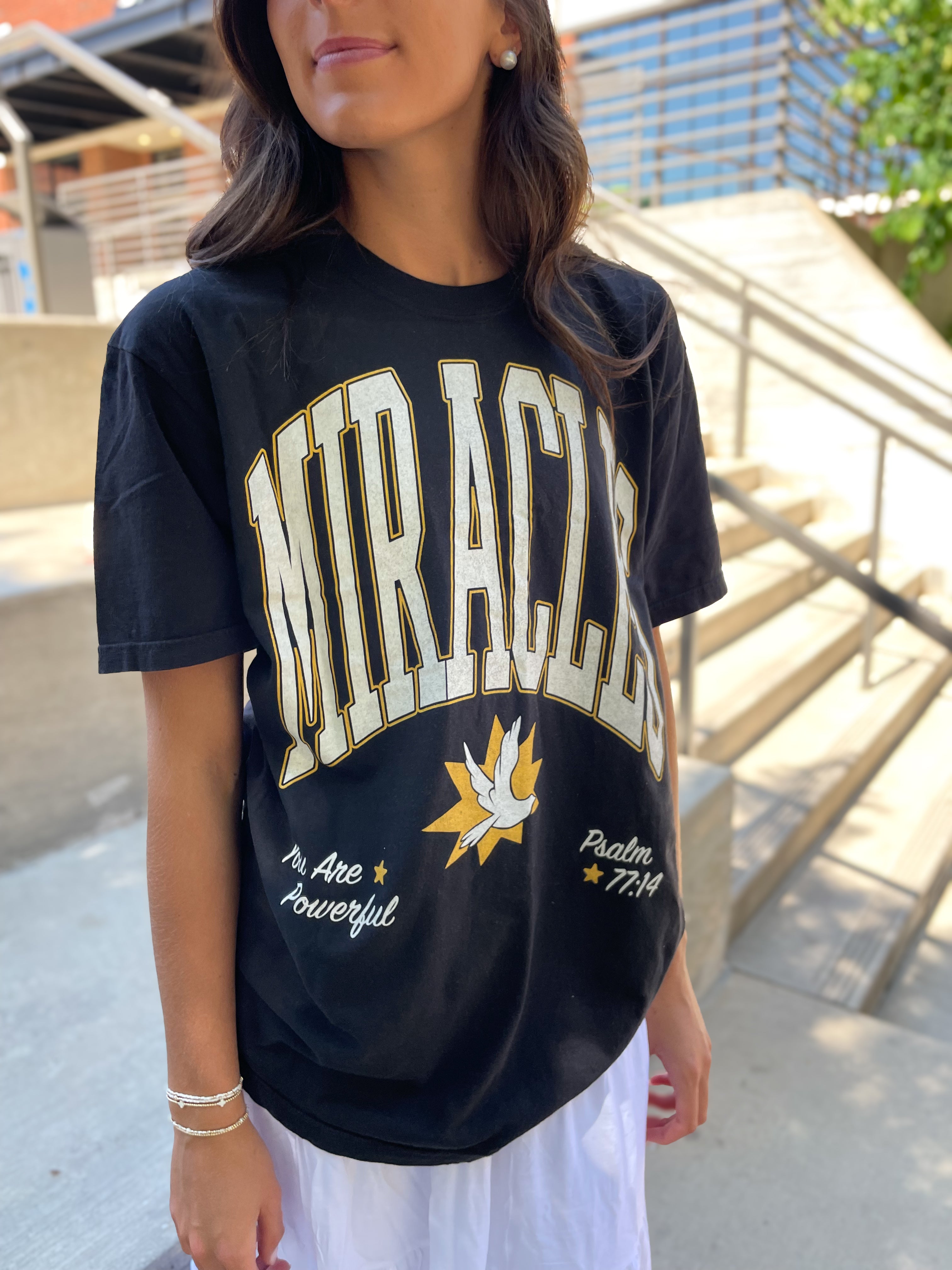 a woman wearing a black shirt and white shorts