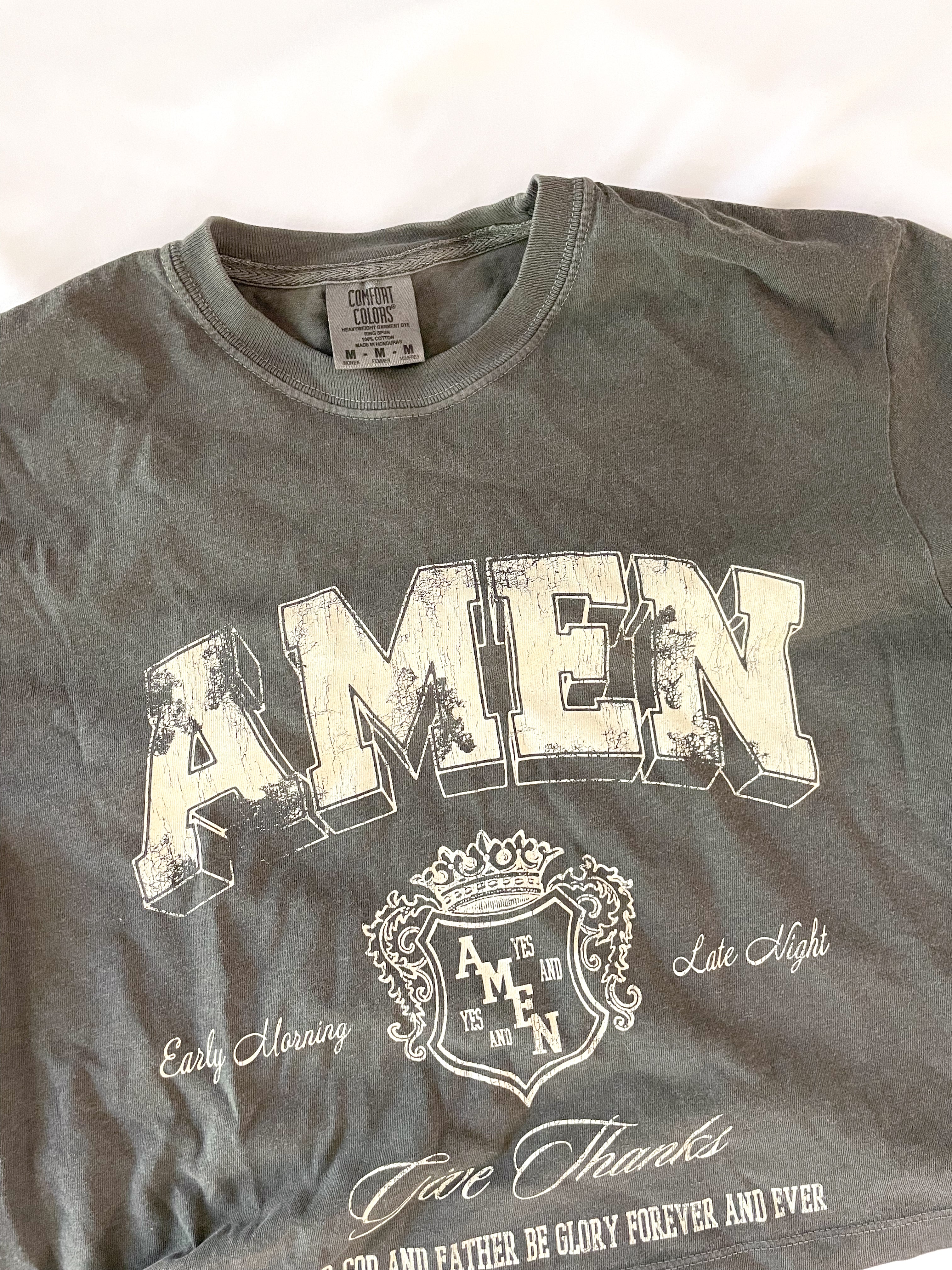 a gray shirt with the word amen printed on it