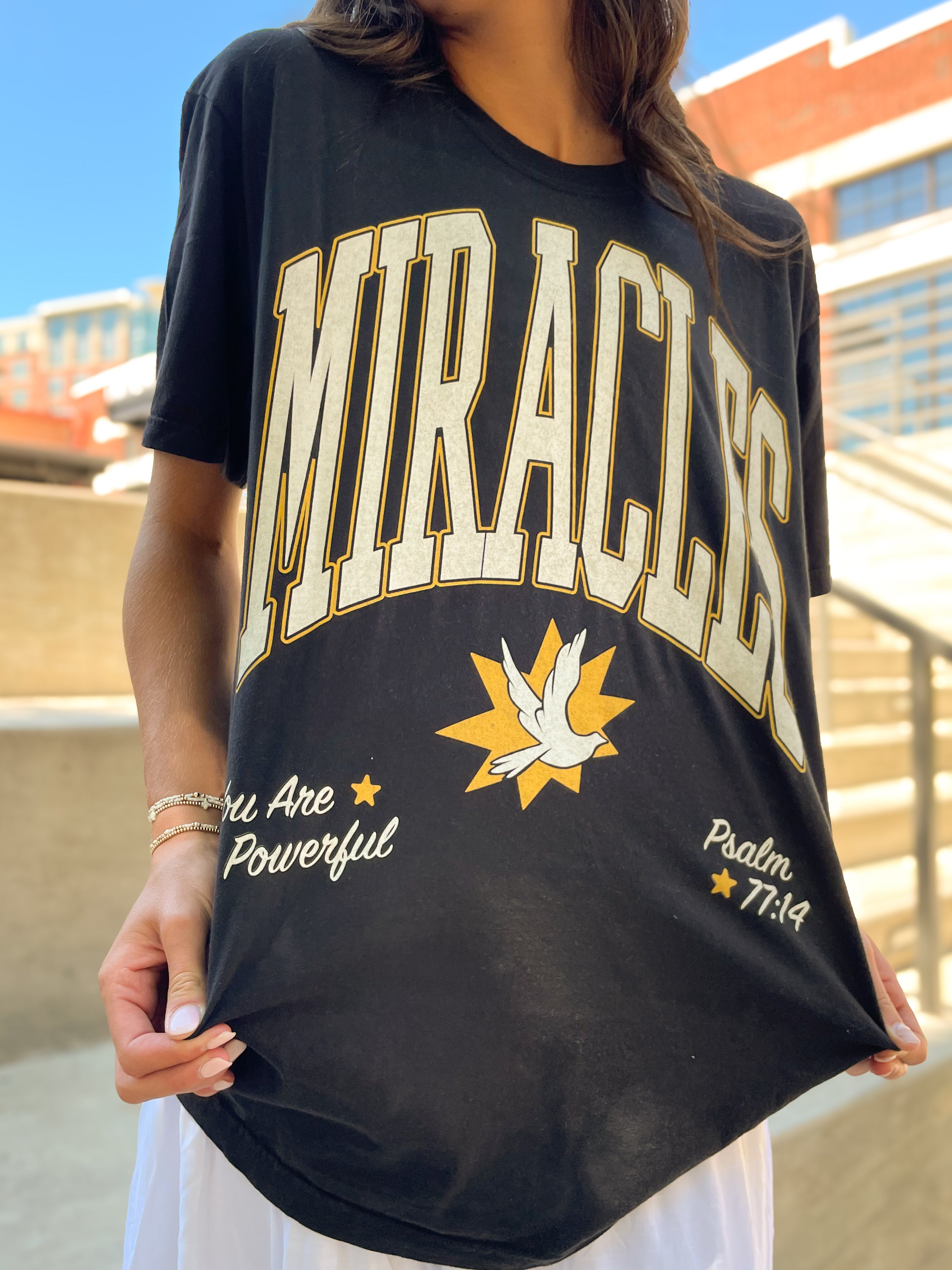 a woman is holding a t - shirt with the word'braces'on