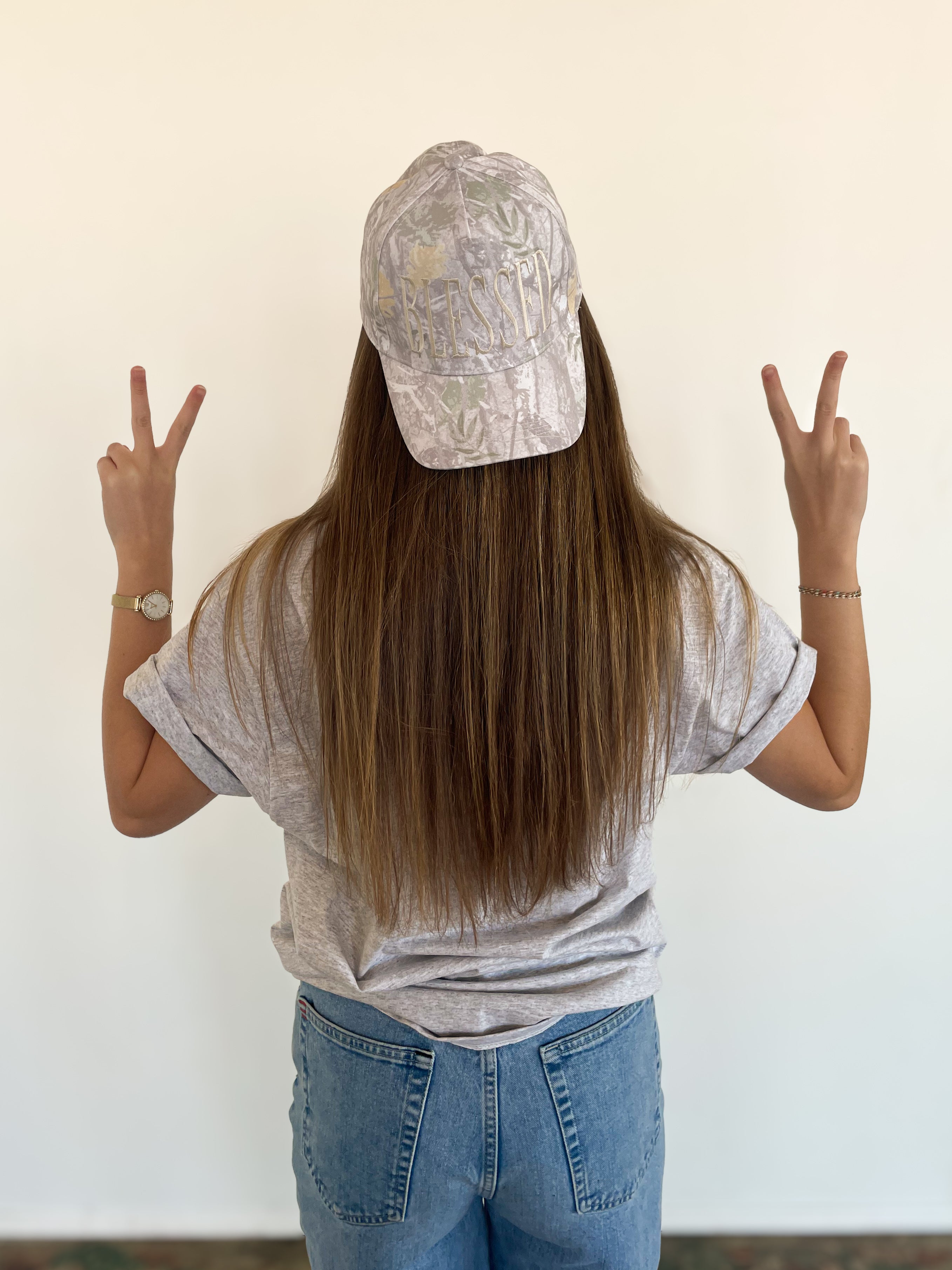 a woman with long hair wearing a hat