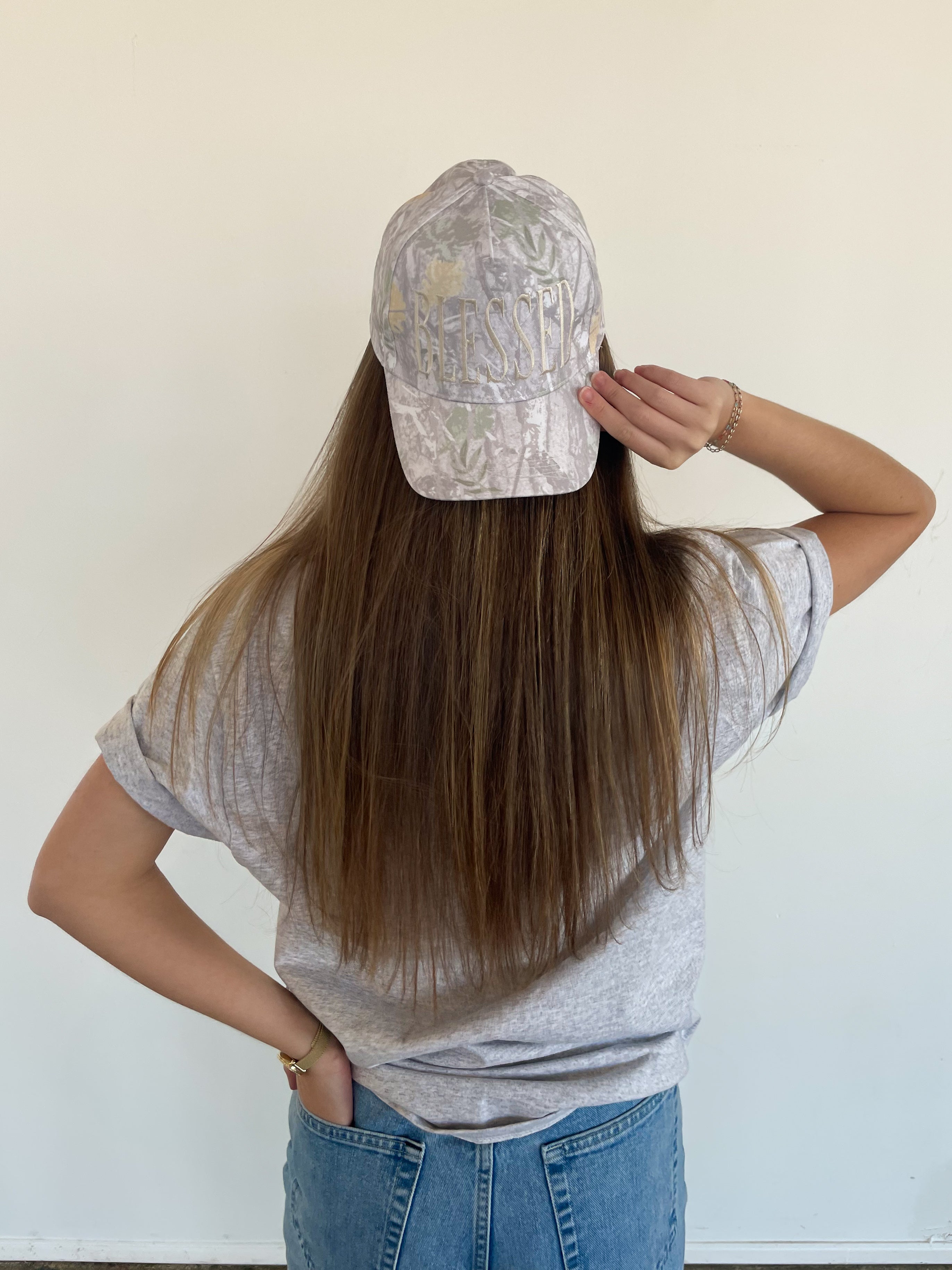 a woman with long hair wearing a hat