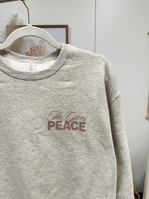 a grey sweatshirt with the words peace printed on it