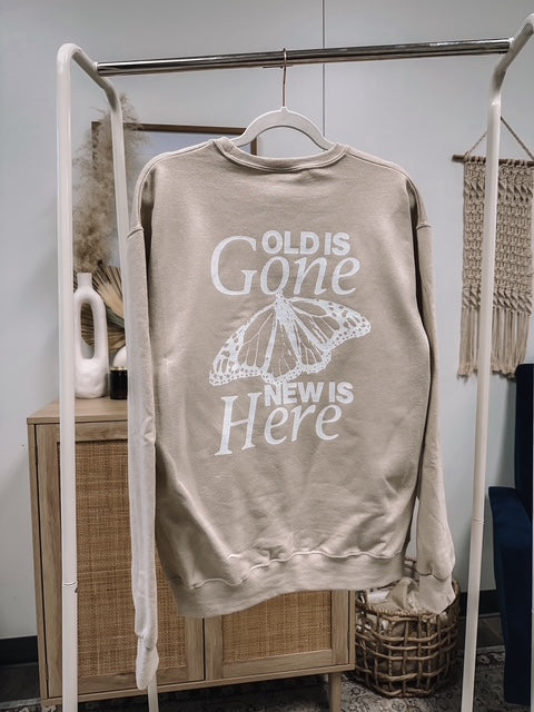 a sweater hanging on a clothes rack in a room