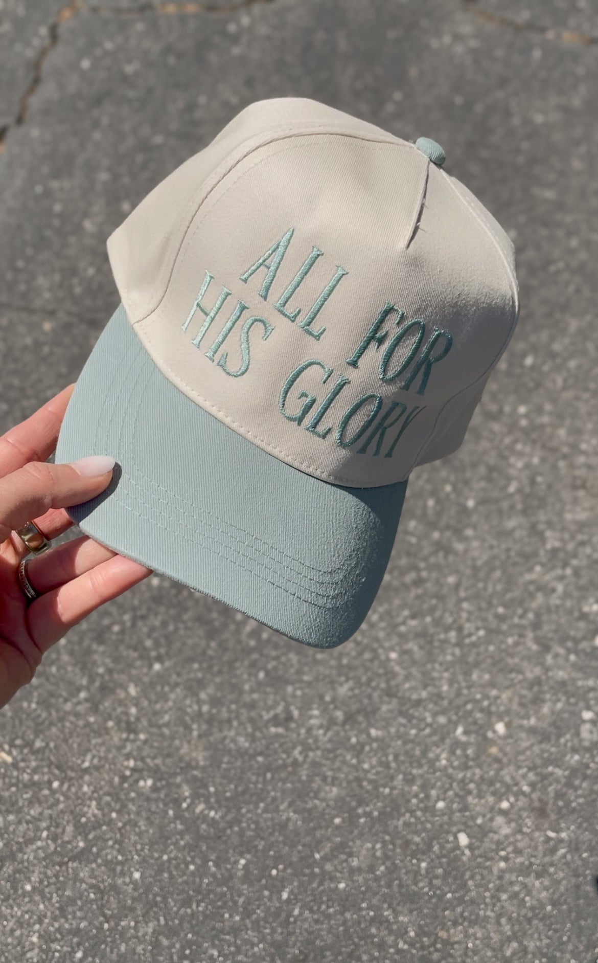 a person holding a hat that says all for his glory