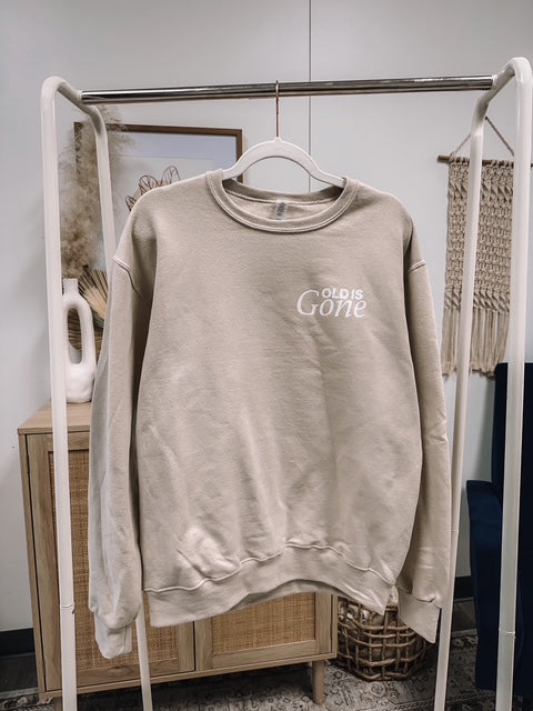 a sweater hanging on a clothes rack in a room