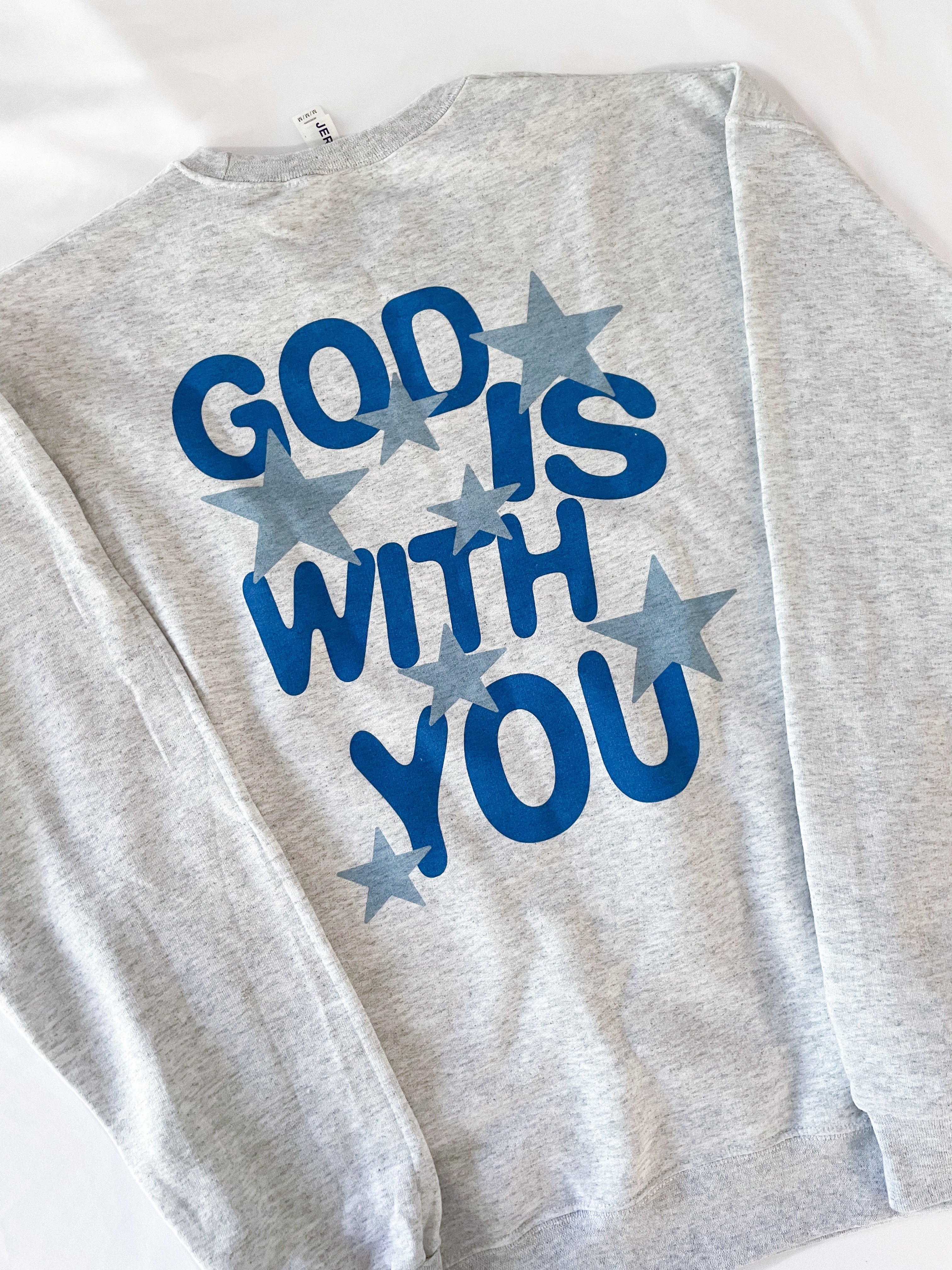 a sweatshirt with the words god is with you printed on it