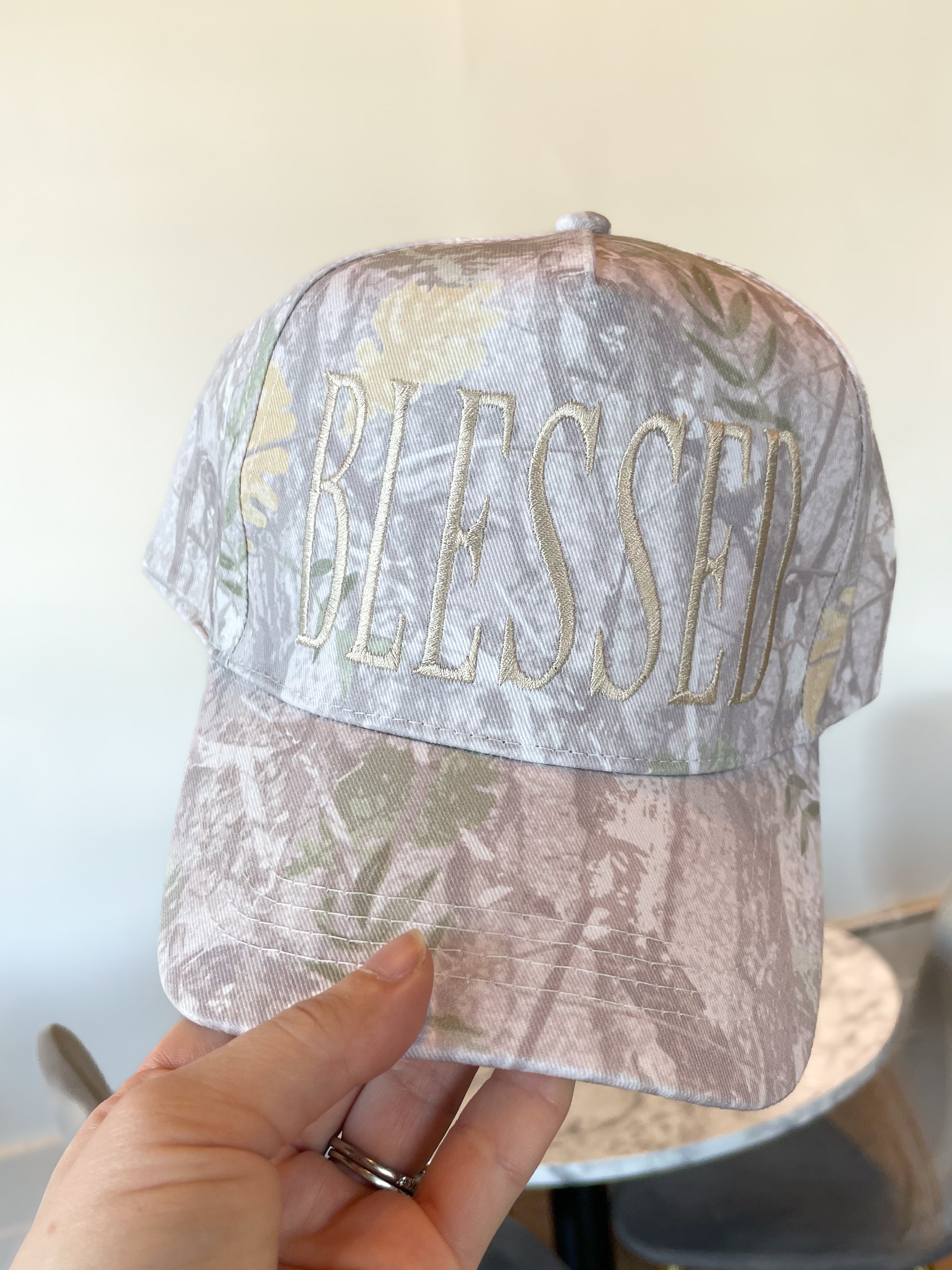 a person holding a hat with the word blessing on it
