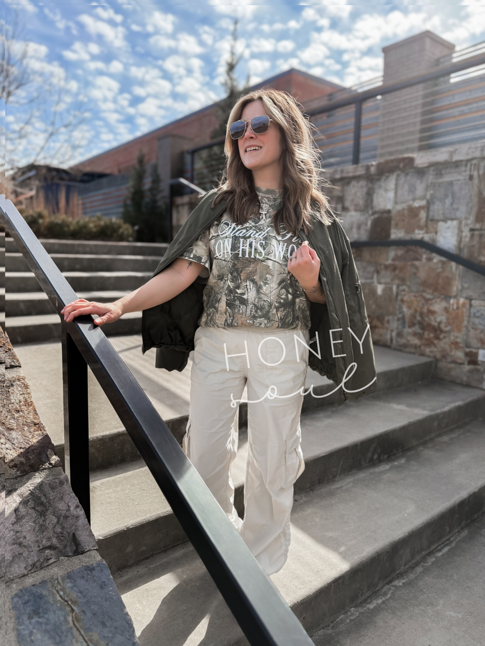 a woman standing on the steps of a building