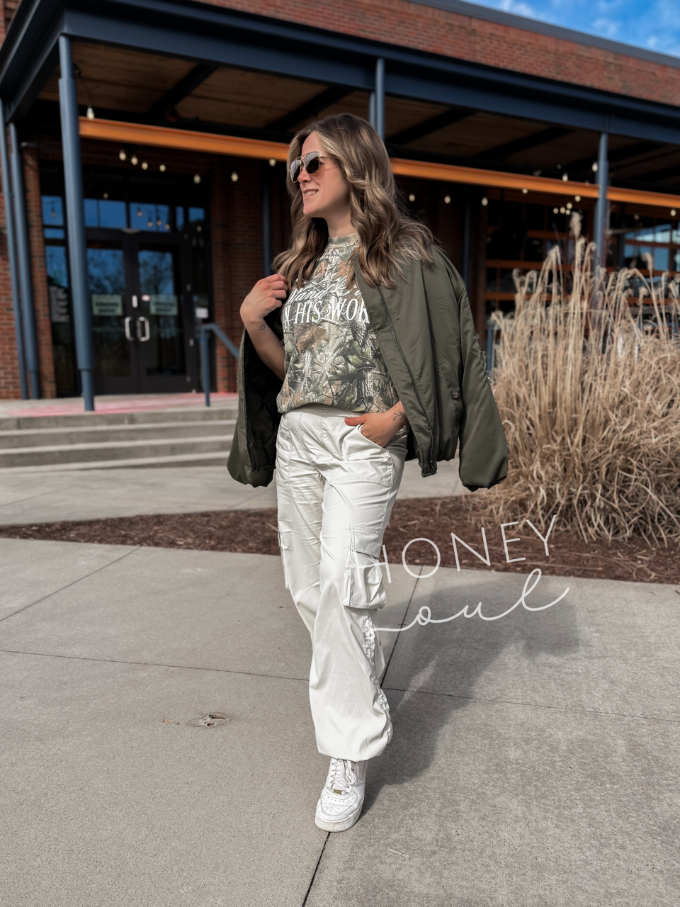 a woman walking down a sidewalk in front of a building