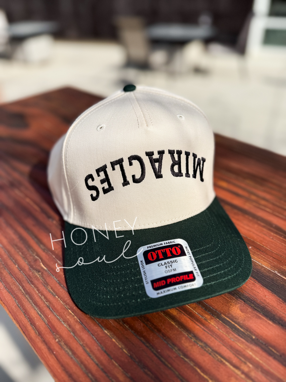 a white and green hat sitting on top of a wooden table