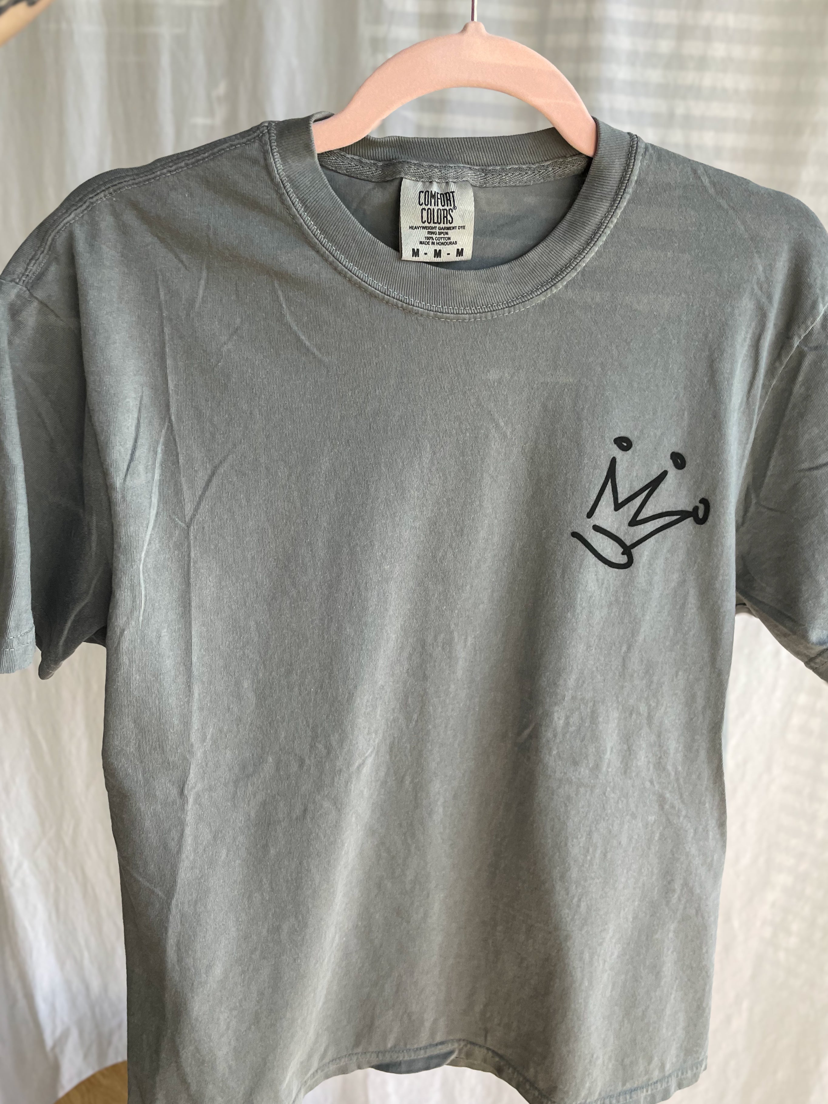 a gray t - shirt with a crown on it