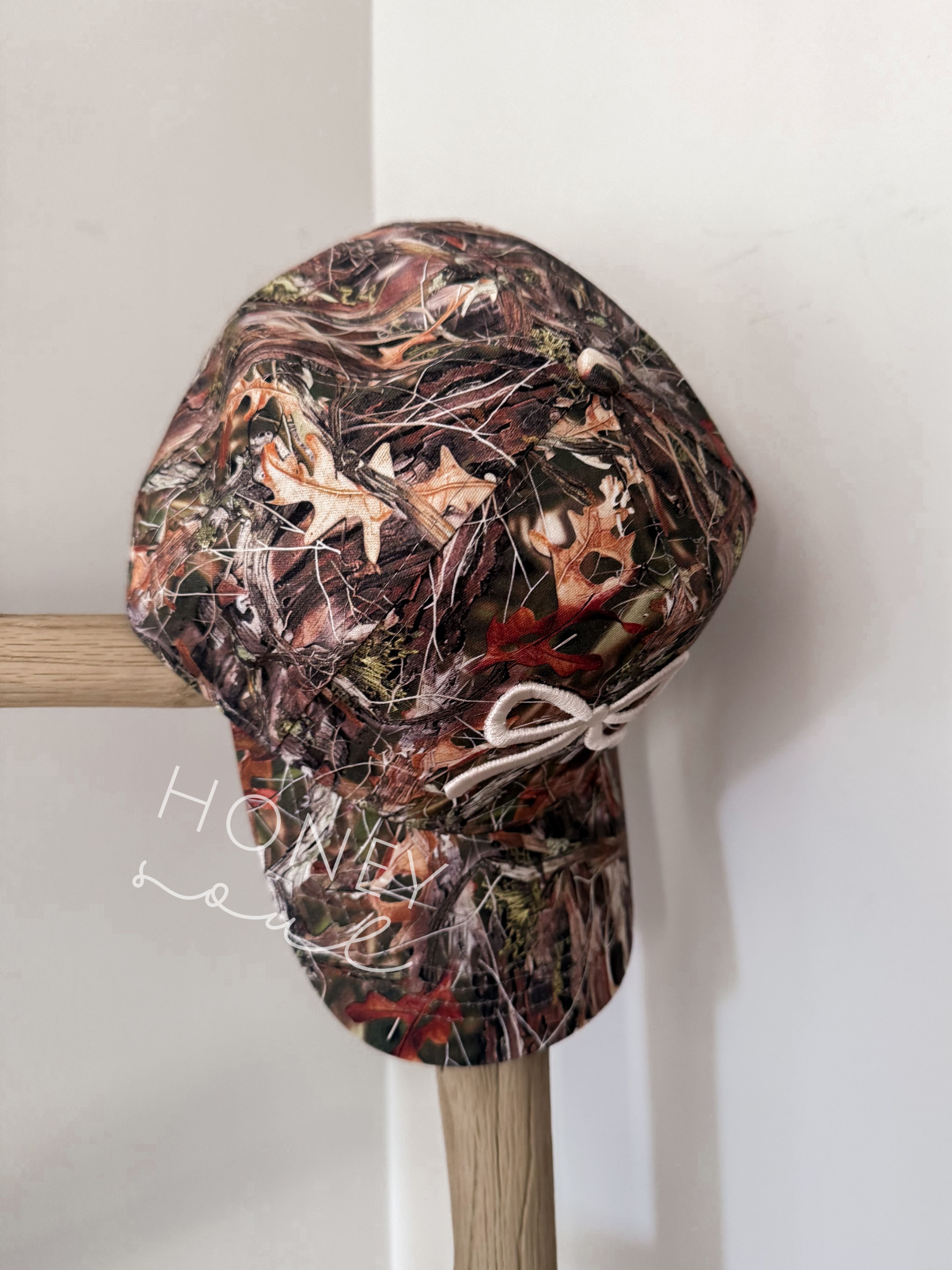 a hat is hanging on a wooden stick