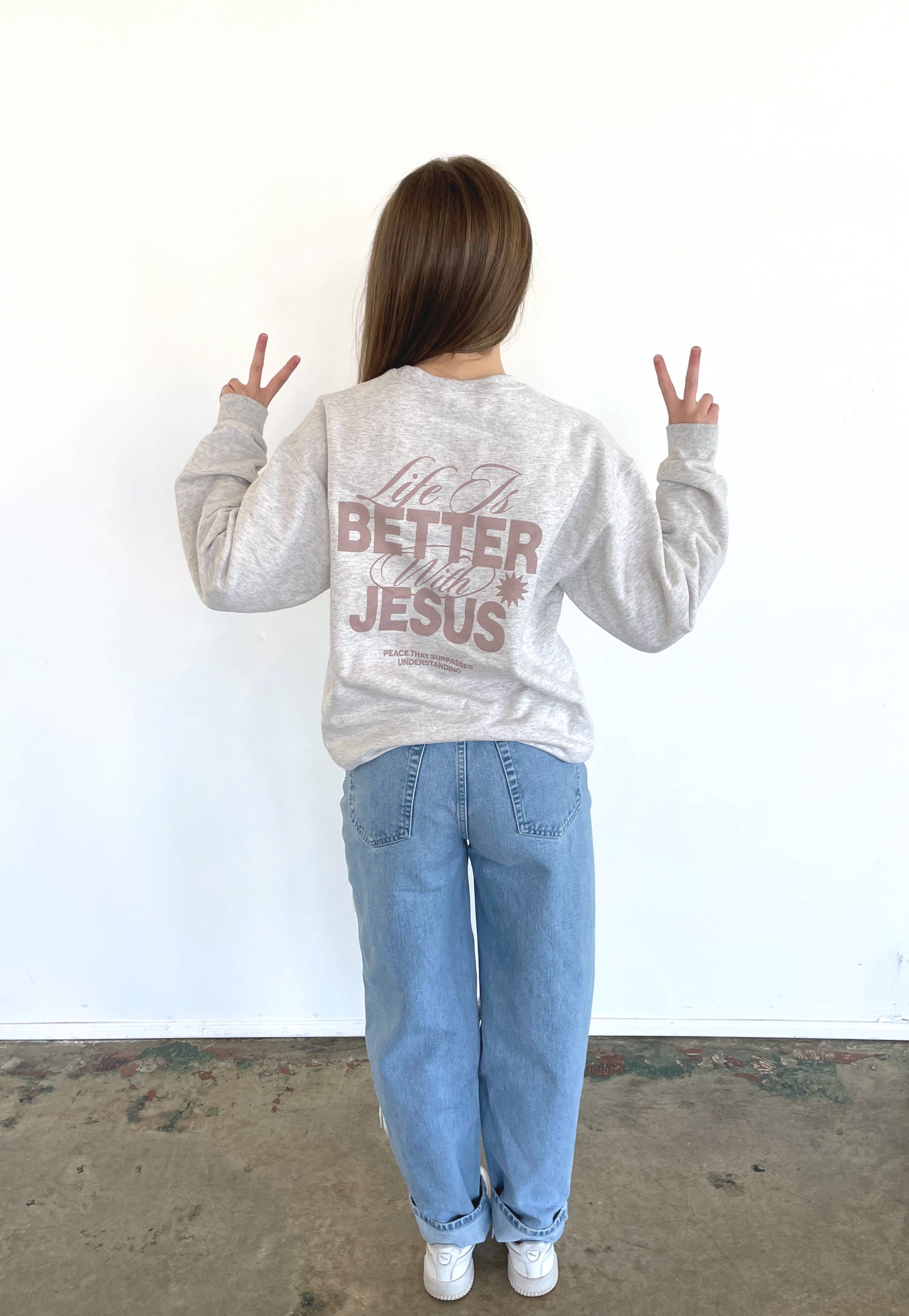 a little girl standing in front of a white wall